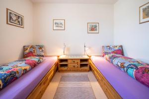 a room with two beds and a table in it at Chasa Munt Plan in Scuol