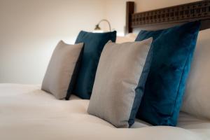 a group of pillows sitting on a bed at Edinbane Lodge in Edinbane
