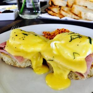 a egg sandwich with ham and cheese on a plate at Taru Villas Kandy in Kandy