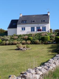 a house on a hill with a grass yard at 622-Ker An Enez la plage au bout du jardin in Esquibien