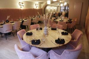 a dining room with tables and chairs and a table and chairsktop at Hotel-Restaurant St-Christophe in Belfort