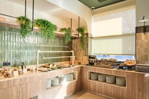 a kitchen with a counter with plates and dishes at Catalonia La Maquinista in Barcelona