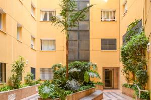 an apartment building with plants in front of it at ESPECTACULAR PISO EN EL CORAZON DE MARBELLA in Marbella