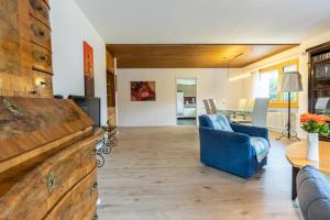 a living room with a blue couch and a table at Chasa Vista Lischana in Scuol