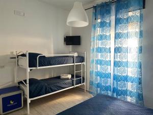 Zimmer mit 2 Etagenbetten und einem Duschvorhang in der Unterkunft Mareluna Bed and Breakfast in Marina di Camerota