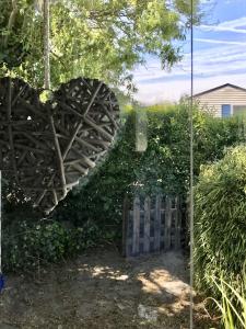 a heart hanging on a fence in a yard at Chalet Strandliebe Bredene in Bredene