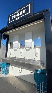 a fuel station with a sink and paper towels at ESN Oktoberfest Campsite in Munich