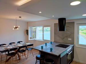 a kitchen with a dining room table and chairs at O Paseo, 5 estrellas. in Puentedeume
