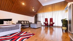 a large living room with a couch and chairs at The Grand Retreat - Chikmagalur in Chikmagalūr