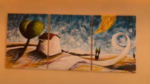 a painting hanging on a wall at villa verde sul mare in Vietri sul Mare