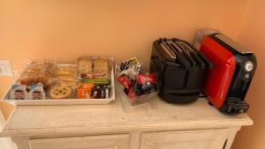 a counter with a table with snacks and a red suitcase at villa verde sul mare in Vietri sul Mare