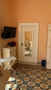 a room with a door with a reflection of a chair at villa verde sul mare in Vietri sul Mare
