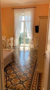 a bedroom with a bed and a large window at villa verde sul mare in Vietri sul Mare