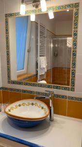 a bathroom with a large mirror and a tub at villa verde sul mare in Vietri sul Mare