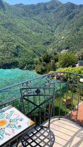 uma varanda com um banco e vista para uma montanha em villa verde sul mare em Vietri