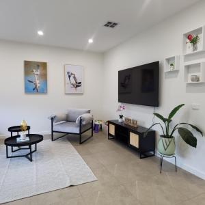 a living room with a flat screen tv on a wall at Altona entire 3 bedrooms house in Altona