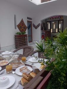 a table with bread and plates of food on it at Art Suzani National House Hotel in Bukhara