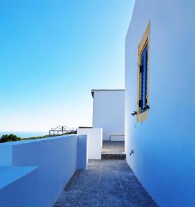 a white building with a window on the side of it at Sophie's Pourko House in Kythira