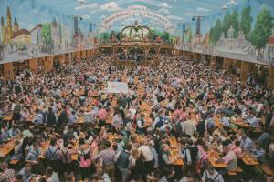 a large crowd of people in an amusement park at ESN Oktoberfest Campsite in Munich