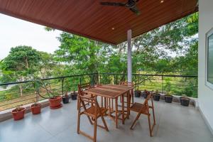 a patio with a table and chairs on a balcony at The Venue By Seasons Suites- in Dod Ballāpur