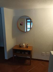 a room with a table and a mirror on the wall at Ca' di Fant Malvaglia in Malvaglia +2 photos