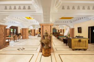 a large lobby with tables and chairs in a building at V Sarovar Portico MI Road Jaipur in Jaipur