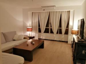 a living room with a couch and a coffee table at ALOJAMIENTO EN CULLERa in Cullera