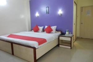 una camera da letto con un grande letto con cuscini rossi di Hotel Mira international - Luxury Stay - Best Hotel in digha a Digha