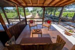 a screened in porch with a table and two chairs at K Bozcaada Revma in Bozcaada