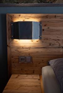 a bedroom with a wooden wall with a microwave at Apartments Wolkentor in Halle an der Saale