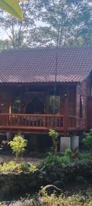 a large wooden house with a roof at Loka Amertha in Sidemen