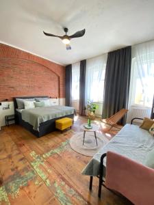 a bedroom with two beds and a brick wall at CARLS AUTHENTIC B&B in Karlovy Vary