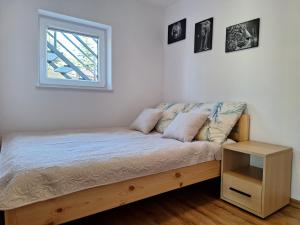 a bed in a room with a window at Węgorzewo- Apartamenty nad stawem in Węgorzewo