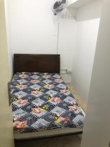 1 dormitorio con cama con edredón en Al Majaz Partition & Rooms en Sharjah