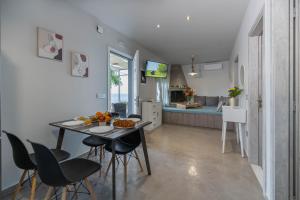 a kitchen and dining room with a table and chairs at Aegean Sunrise View in Archangelos