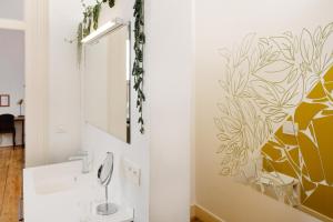 a bathroom with a sink and a mirror at B&B DRUUM in Brussels