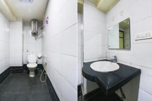 a bathroom with a sink and a toilet at FabHotel Royal Residency Lakdikapul in Hyderabad