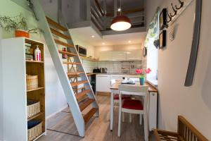 a kitchen with a staircase and a table and chairs at Apartament Rekowo in Kamień Pomorski