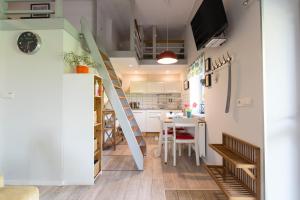 a kitchen and dining room with a staircase in a tiny apartment at Apartament Rekowo in Kamień Pomorski