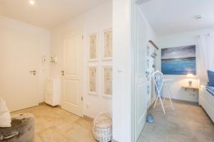 a white room with a hallway with a door at Sonnenaufgang in Zingst
