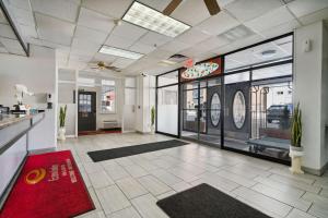 a lobby of a restaurant with a red rug at Econo Lodge Inn & Suites in Waterloo