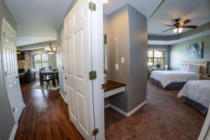 a bedroom with two beds and a dining room at Tanglewood Resort, Ascend Hotel Collection in Pottsboro