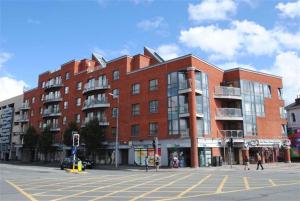 a large red brick building on a city street at CamdenWharf in Cork