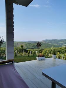 a patio with a table and a view of the hills at Villa Arisi in Pristina