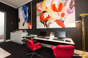 un ufficio con sedie rosse e una scrivania con un computer di Tolarno Hotel - The Philippe - Australia a Melbourne