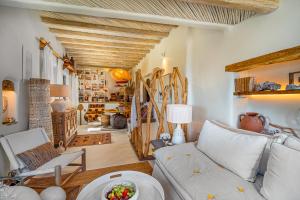 a living room with a couch and some skis at Fos of Serifos in Serifos Chora