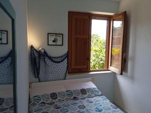 a bedroom with a bed and a window at Il tempio sulle isole in Erice +22 photos