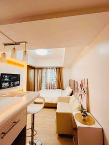 a small living room with a couch and a table at Elitista Chateau Azure North Pampanga in San Fernando