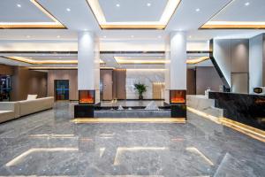 a lobby of a hotel with marble floors and ceilings at Jiuzhai Journey Hotel in Jiuzhaigou