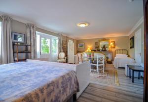 a bedroom with a large bed and a dining room at The Quay House, Clifden in Clifden